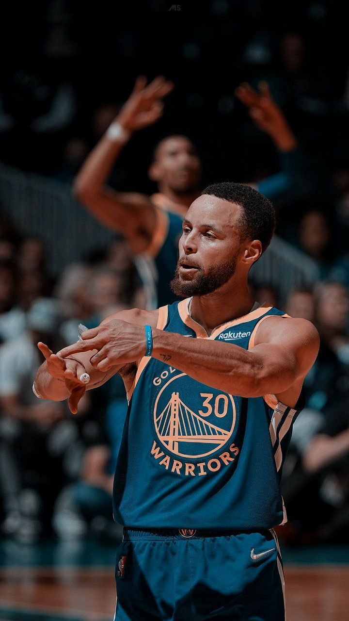 Stephen Curry taking a three-point shot 